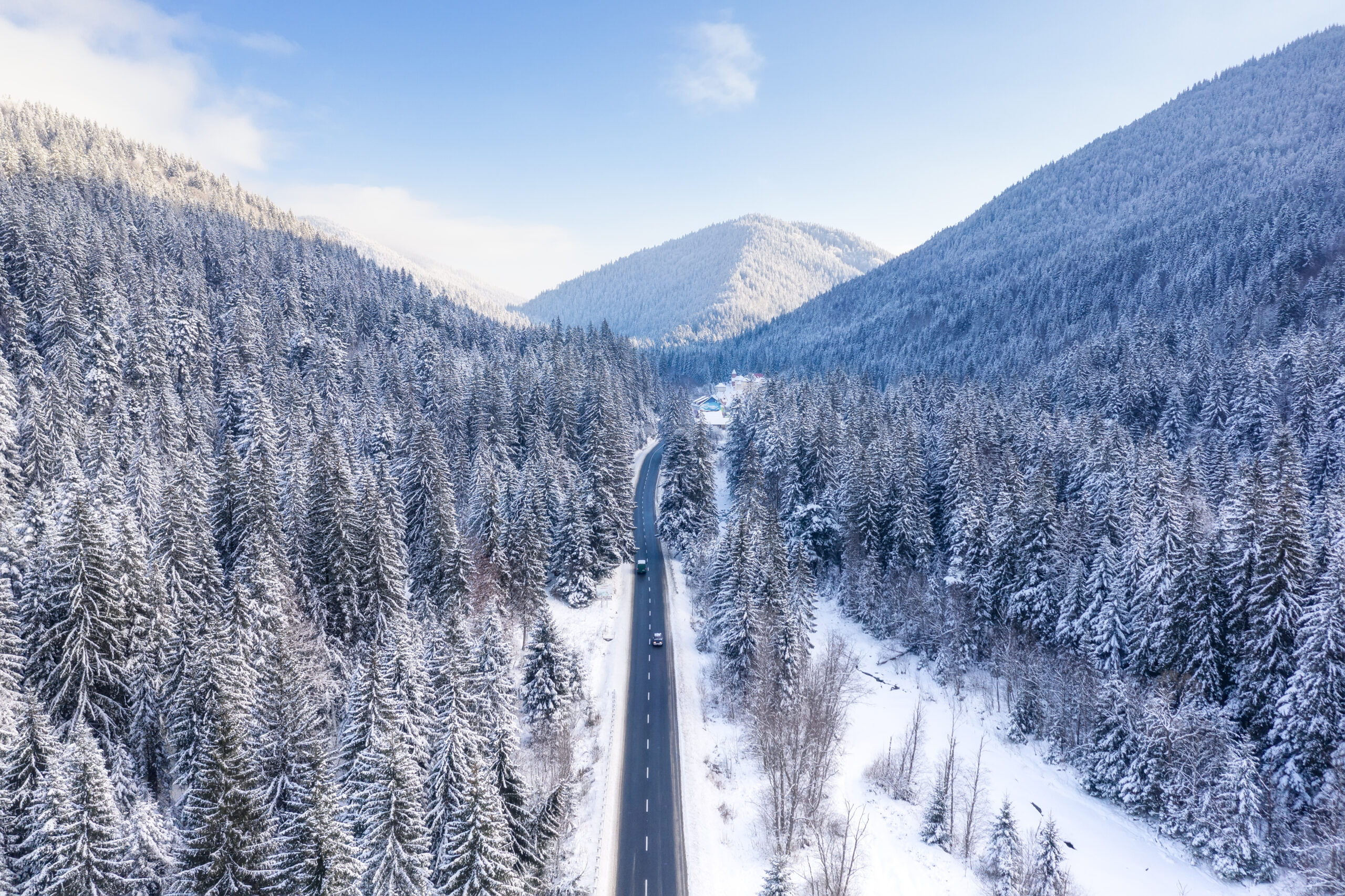 Aerial view on the road and forest at the winter time. Natural winter landscape from air. Forest under snow a the winter time. Landscape from drone